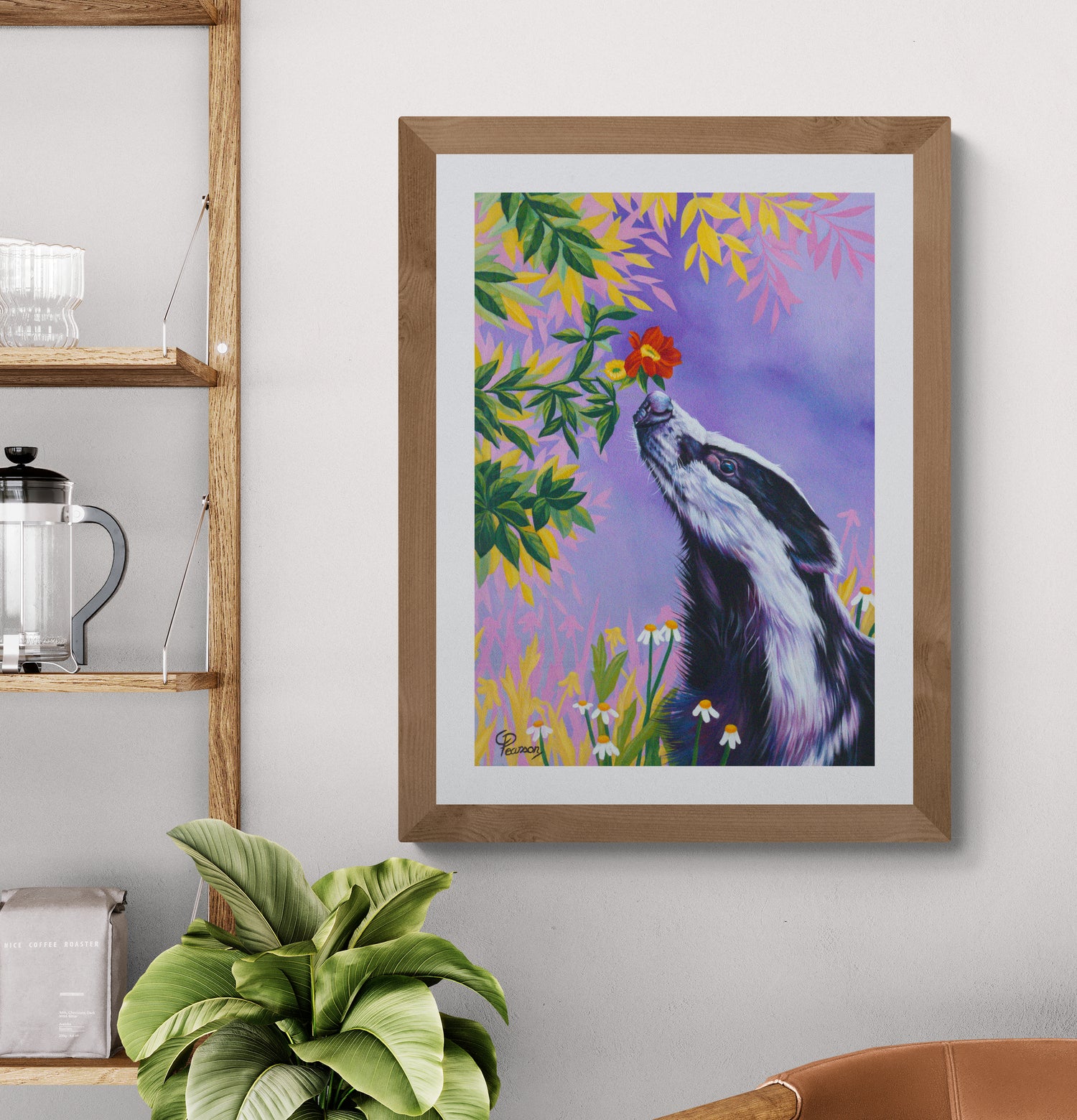 Framed painting of a Badger smelling flowers on a wall with shelves and a plant.