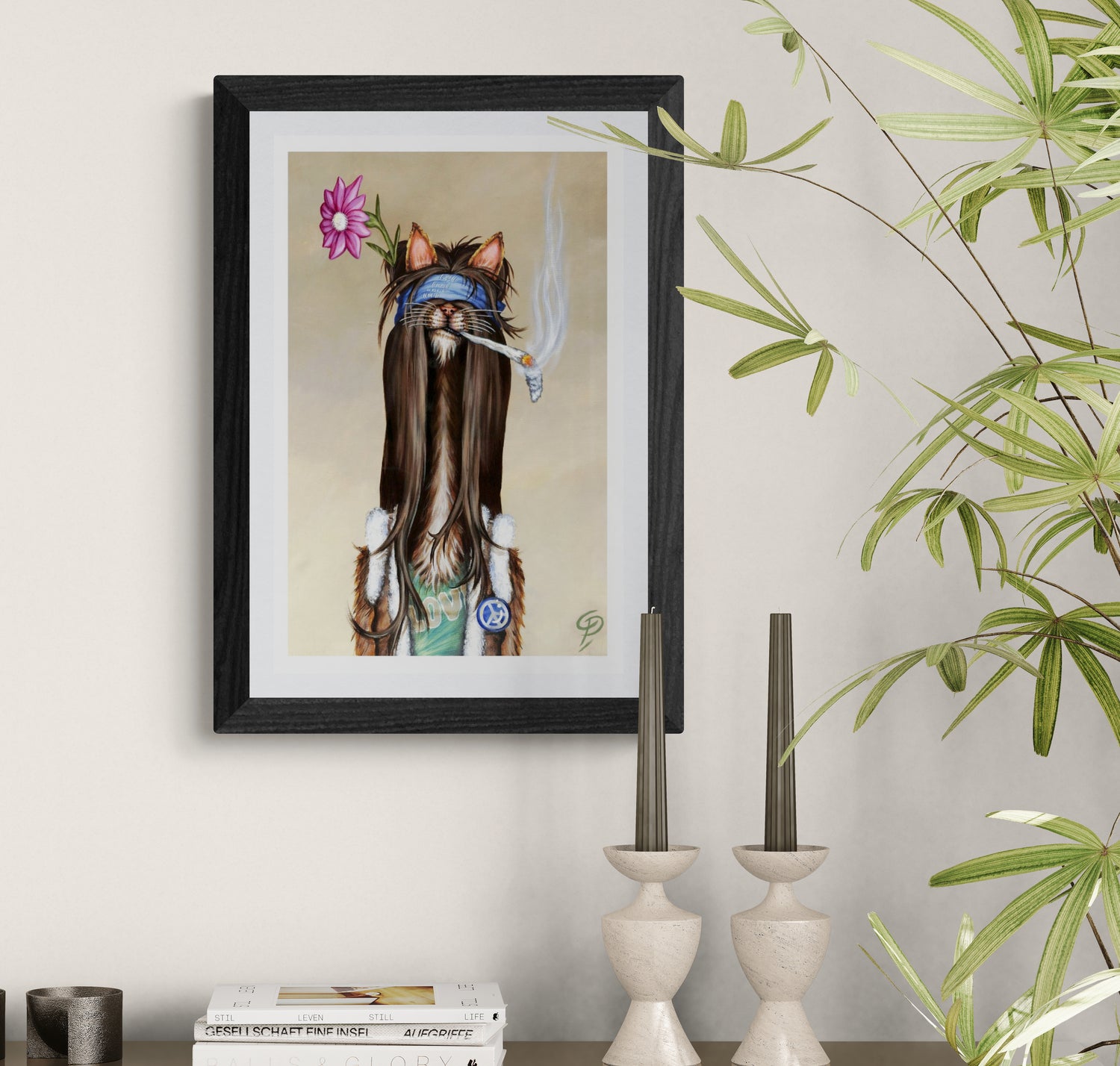 Framed artwork of a cat with long hair, flowers, and a blue bandana on a wall.