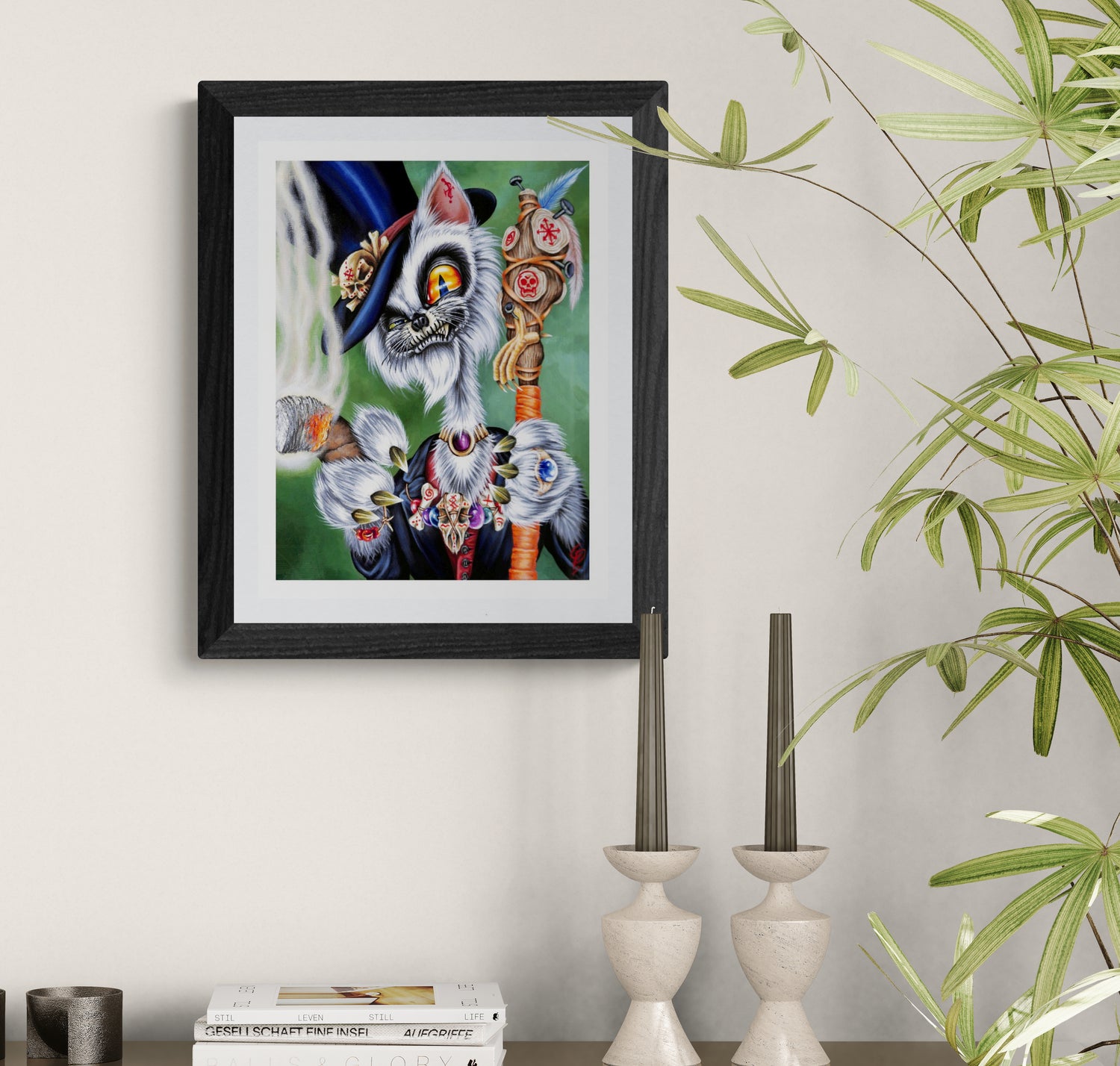Framed artwork of a colorful cat with a hat on a wall next to decorative candles and plants.