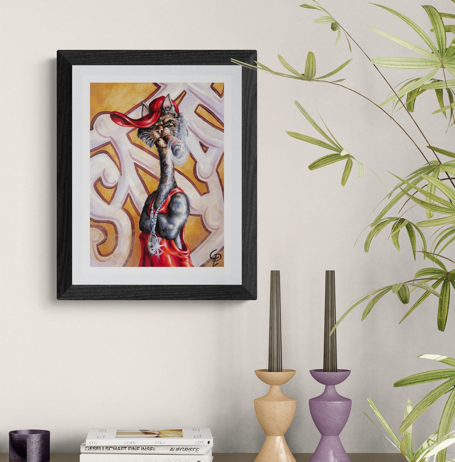 Framed artwork of cat  on a wall with decorative candles and books below